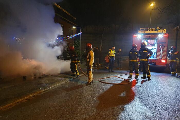 Brandweer blust brandend afval