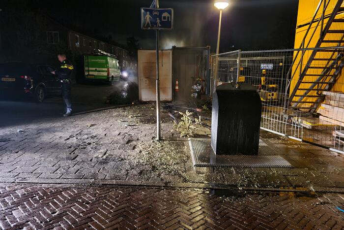 Kerstbomen tegen bouwcontainer in brand gestoken