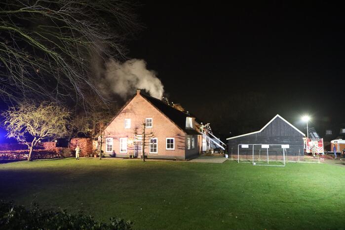 Brand in schoorsteen slaat over op rietenkap