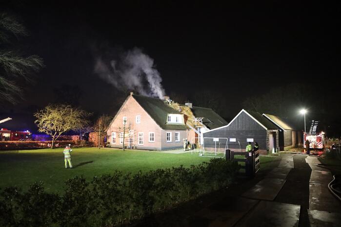 Brand in schoorsteen slaat over op rietenkap