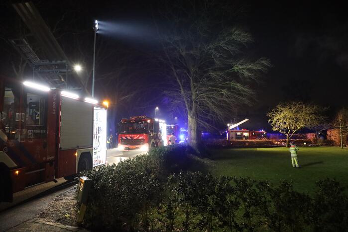 Brand in schoorsteen slaat over op rietenkap