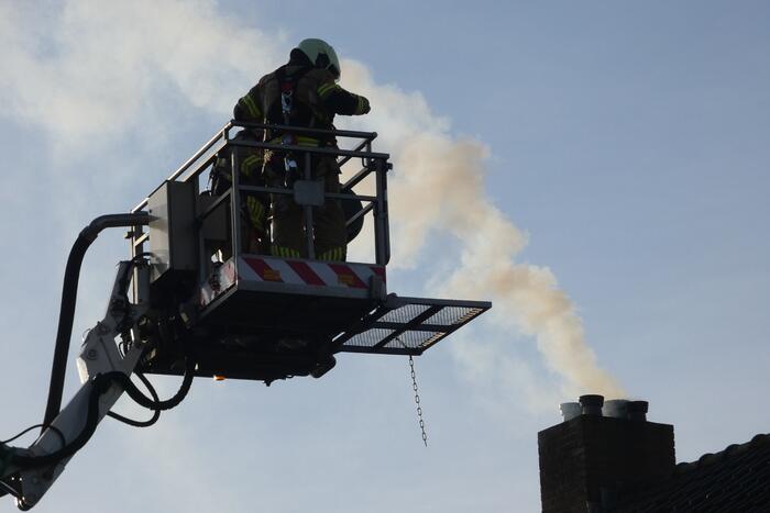 Brandweer veegt schoorsteen na brand