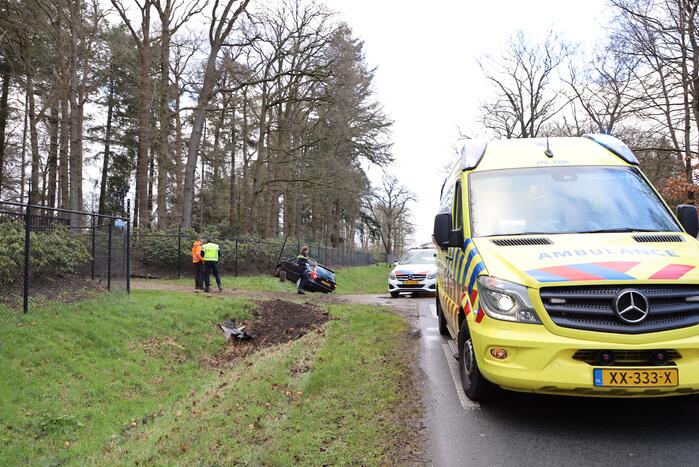 Auto eindigt aan overkant van de weg in hekwerk