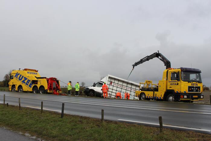 Bestelbus met glas belandt in sloot