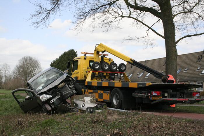 Auto botst op betonblok met lantaarnpaal