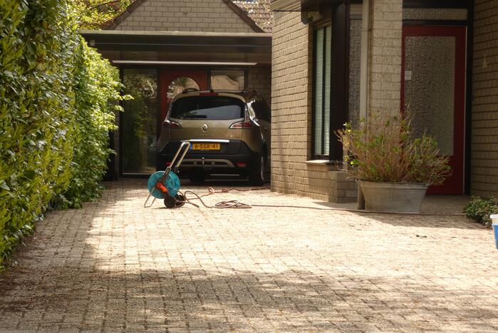 Bewoners blussen coniferenbrand met emmers en tuinslang