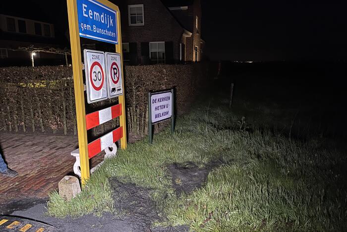 Brandweer blust brandende band op midden van weg