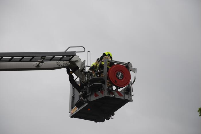 Brandweer blust brand in schoorsteen