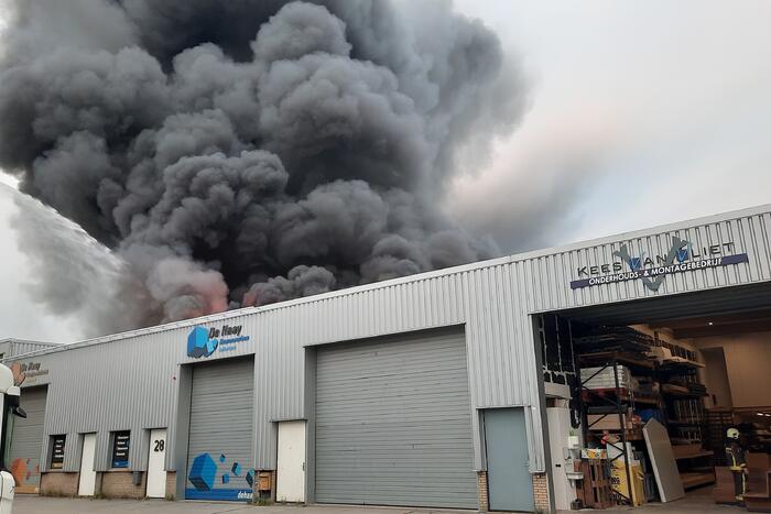 Dikke zwarte rookwolken bij uitslaande brand