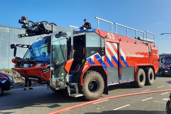 Dikke zwarte rookwolken bij uitslaande brand