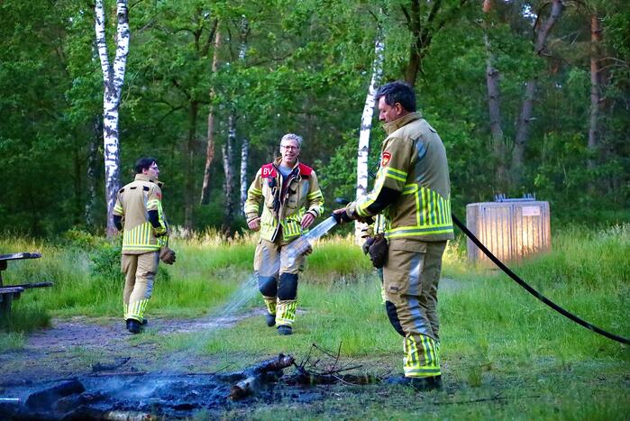 Stapel houten takken in brand in bosgebied De Bergjes