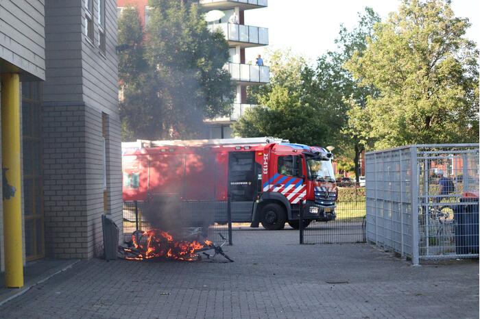 Brandweer blust brandende stapel fietsen