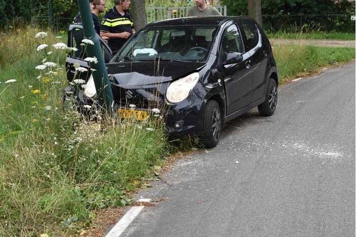 Automobilist parkeert auto tegen lantaarnpaal