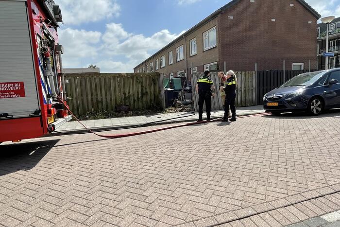 Schutting in achtertuin beschadigd door brand
