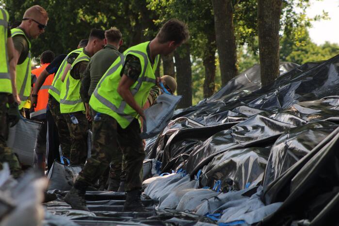 Leger versterkt dijk met zandzakken