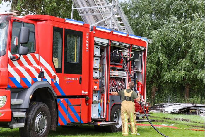 Brand in houtopslag slaat over naar schuur