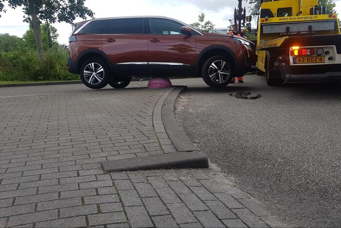 Auto belandt op betonnen sierbol