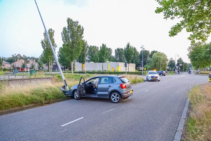 Auto knalt op lantaarnpaal