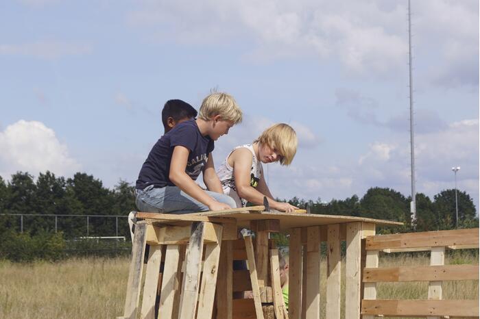 Kinderen timmeren hun eigen hutten