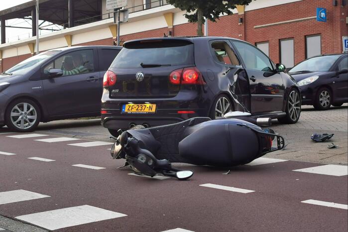 Scooter en auto botsen op elkaar