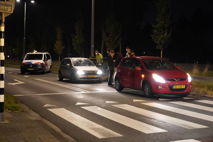 Twee personenauto's botsen op elkaar voor verkeerslicht