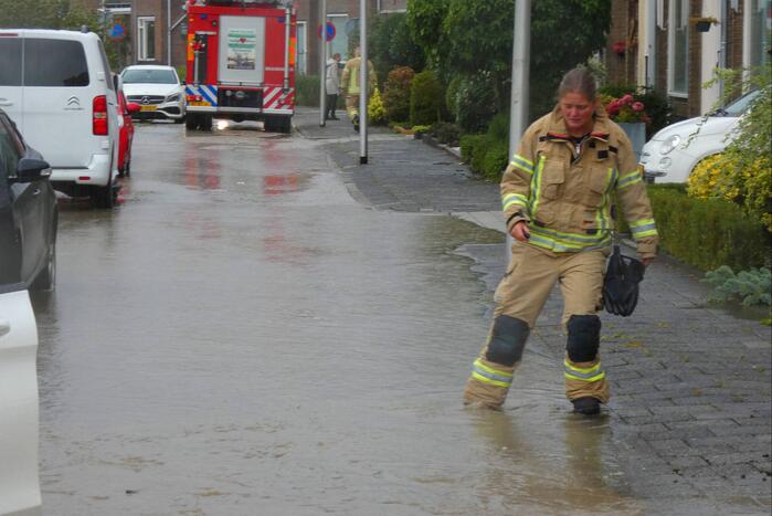 Straat onderwater door gesprongen waterleiding