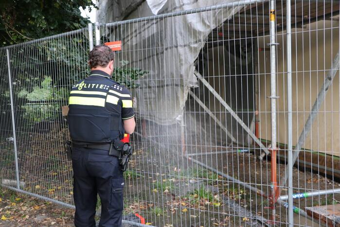 Omstanders blussen brand op bouwplaats