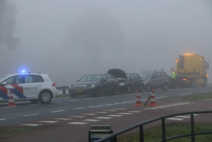 Drie auto's botsen in dichte mist