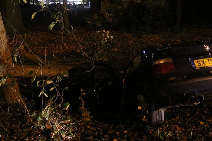Auto botst tegen boom en belandt in sloot