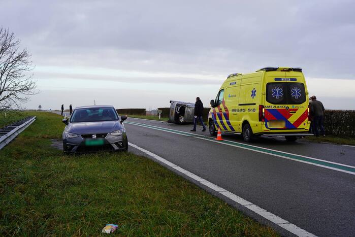 Auto op zijn kant bij verkeersongeval