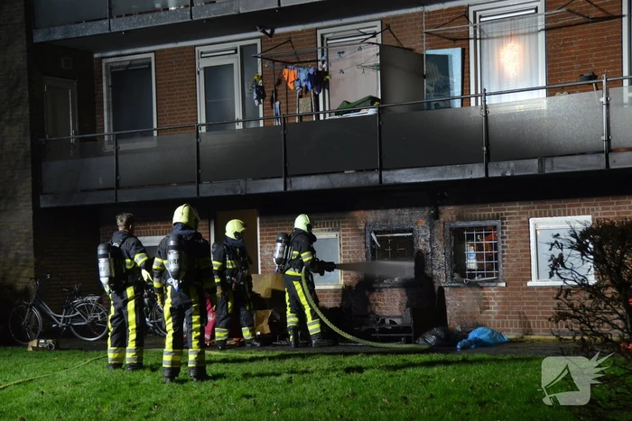 Bank in brand onder balkon van flat