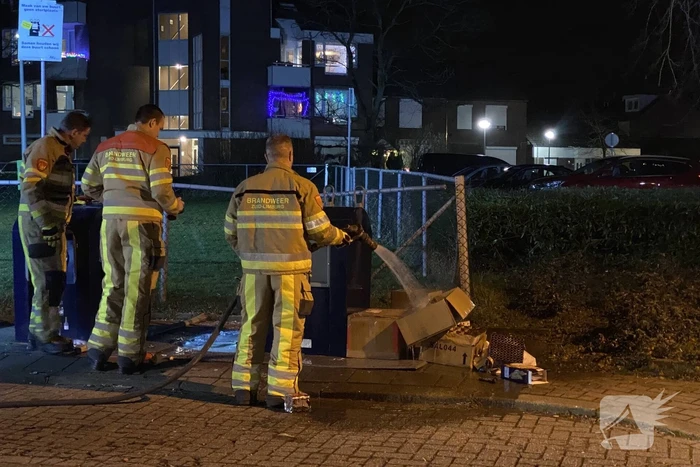 Oud papier tegen container in brand