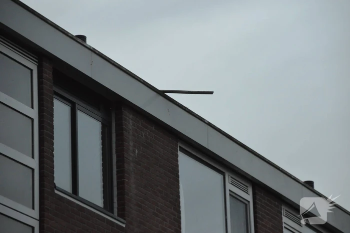 Stuk daklijst dreigt van gebouw te waaien