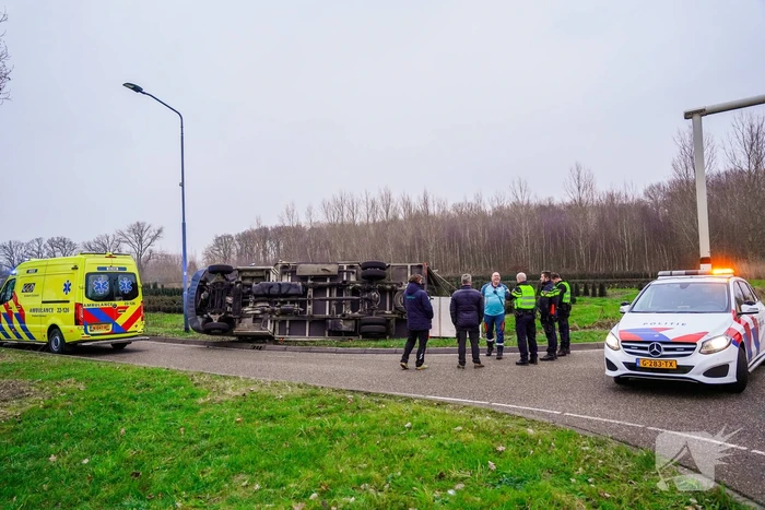 Bestelbus kantelt en belandt in sloot