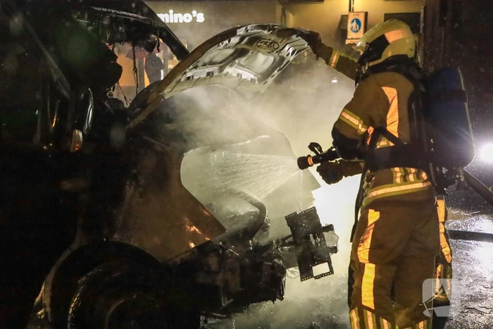 Bestelbus in brand tegen gevel Jumbo