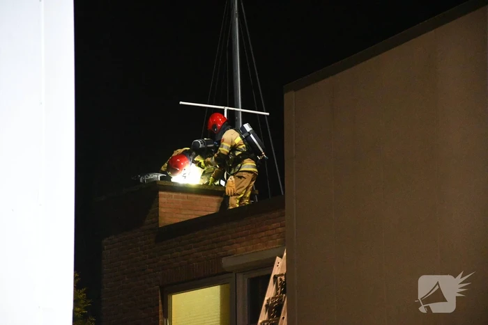 Brandweer blust brand in schoorsteen