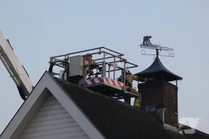 Brandweer blust brand in schoorsteen