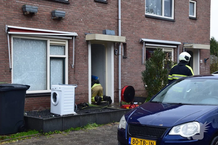Wasmachine in woning vat vlam
