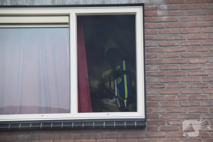 Wasmachine in woning vat vlam
