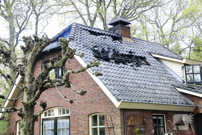Vlammen slaan uit dak van vrijstaande woning