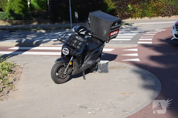 Maaltijdbezorger op scooter gaat hard onderuit