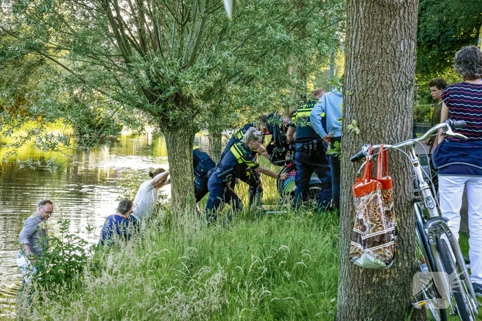Personen op rolstoelfiets raken te water