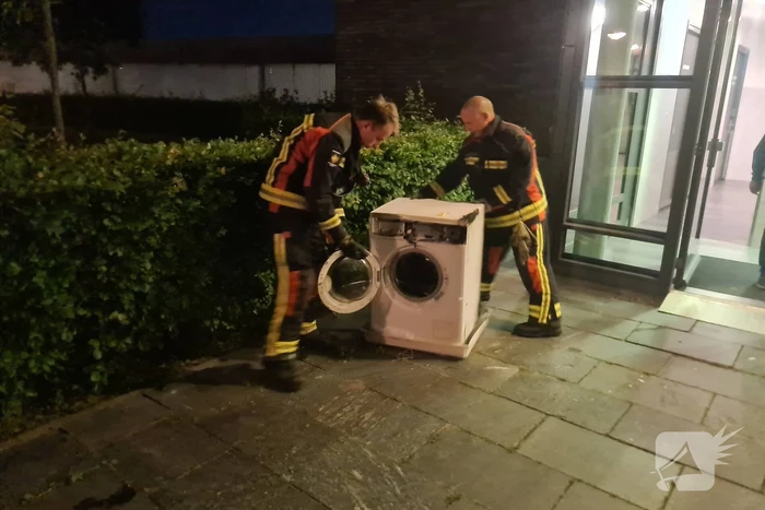 Brand in flat door wasmachine