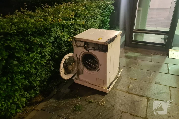 Brand in flat door wasmachine