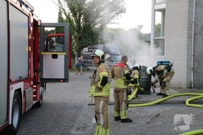 Brandweer blust brandende container