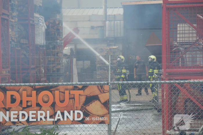 Uitslaande brand in gestapelde haardhout-boxen