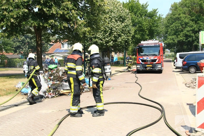 Lading vuilniswagen vat vlam