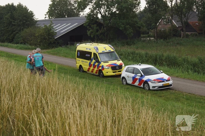 Vrouw door ambulancemedewerkers van dijk gedragen