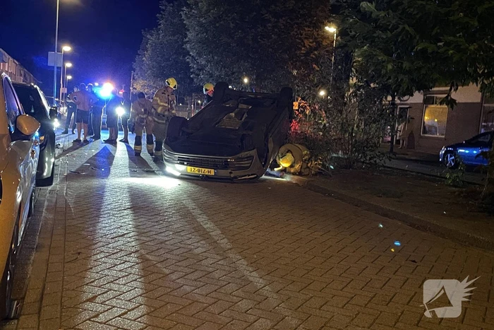 Auto slaat over de kop na botsing tegen stilstaande auto's