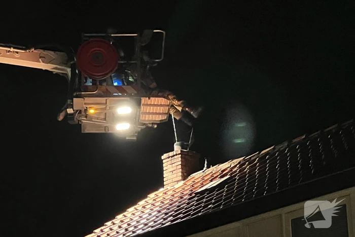 Brandweer veegt schoorsteen na brand